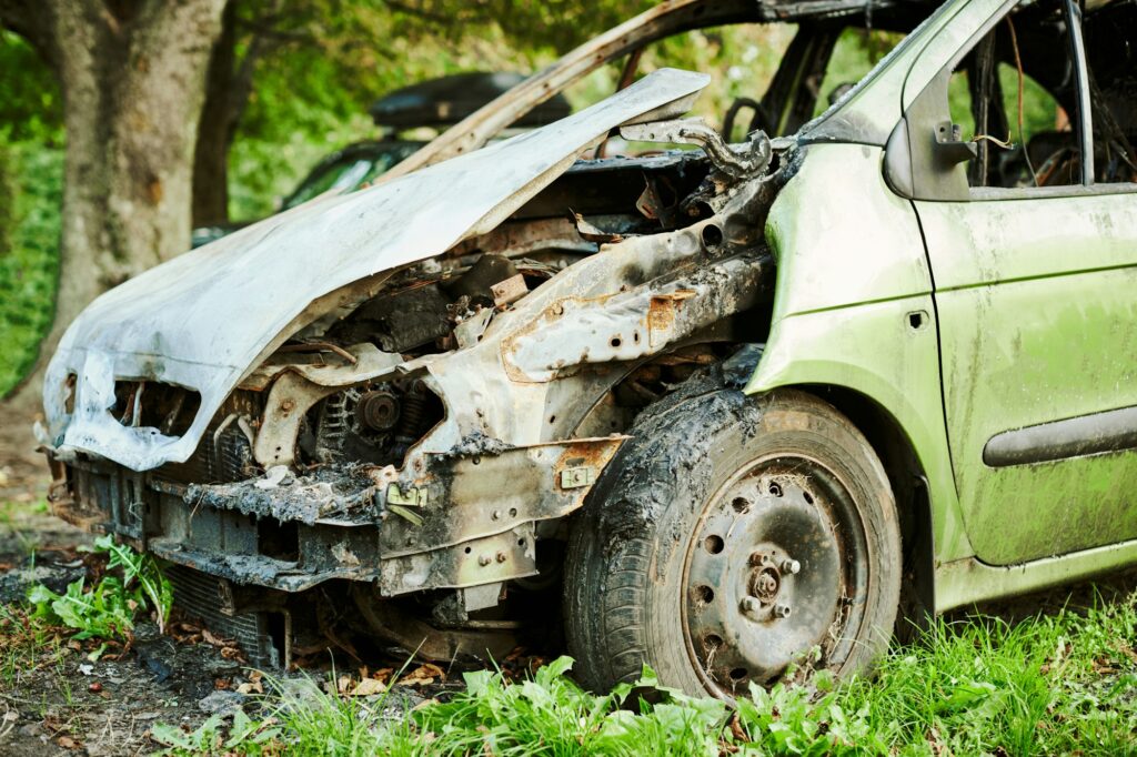 Burned car exterior, vehicle fire due to short circuit, arson, fire damaged motor vehicle, car fire